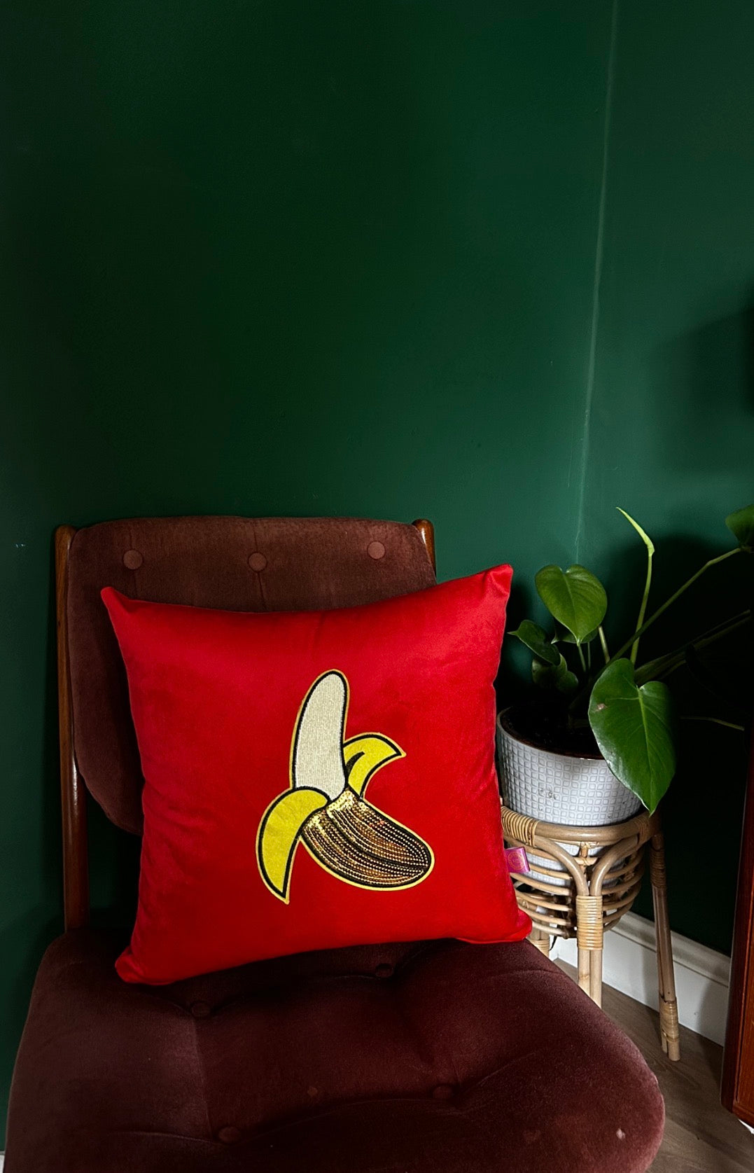 Red velvet cushion with large banana
