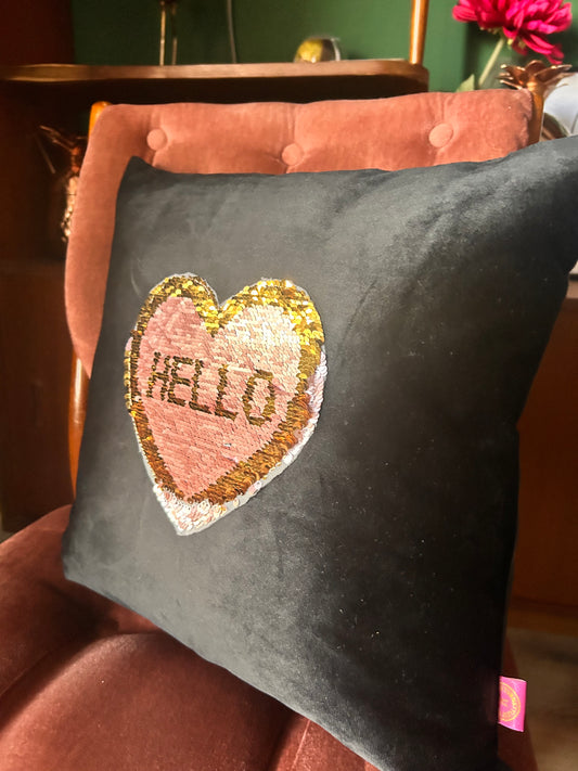 Black velvet cushion with reversible pink and gold sequins
